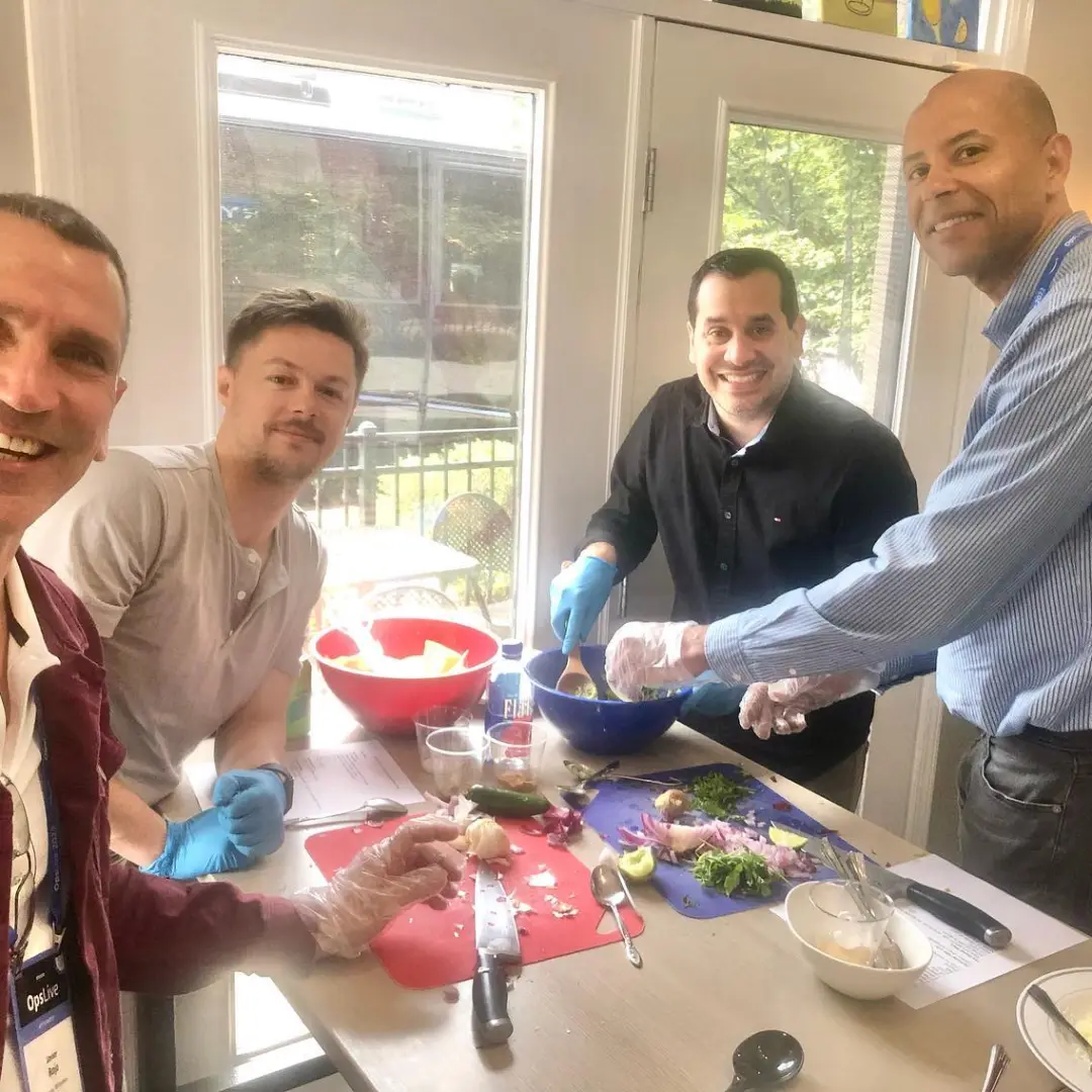 a group of people standing around a table