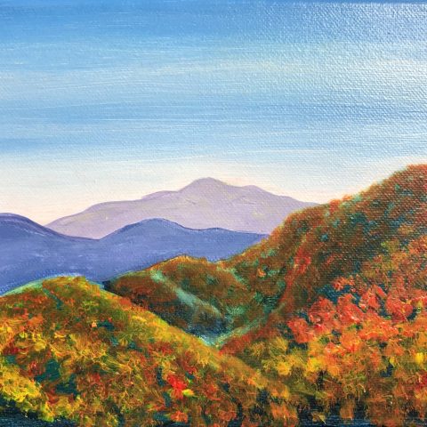 a body of water with a mountain in the background