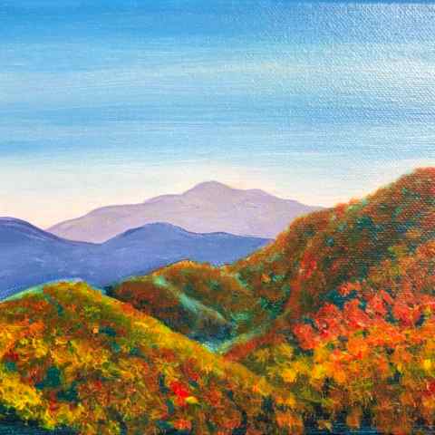 a body of water with a mountain in the background