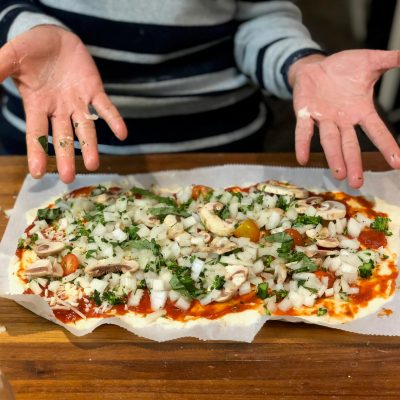 a pizza sitting on top of a wooden cutting board