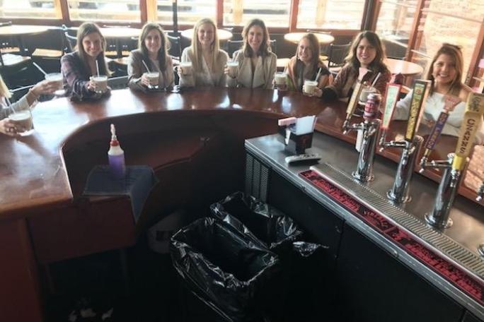a group of people sitting at a table with wine glasses