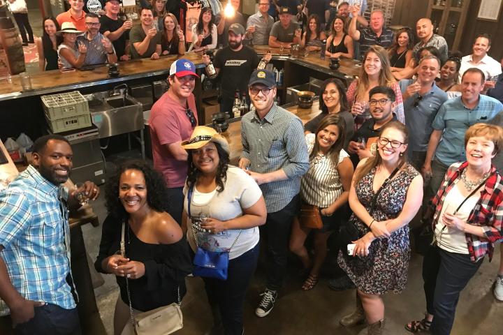 Kevin O'Sullivan et al. standing in front of a crowd posing for the camera