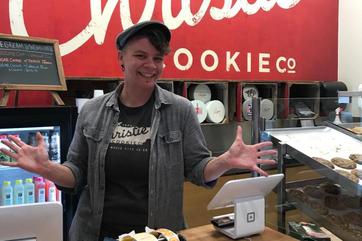 a person holding a stop sign in front of a store