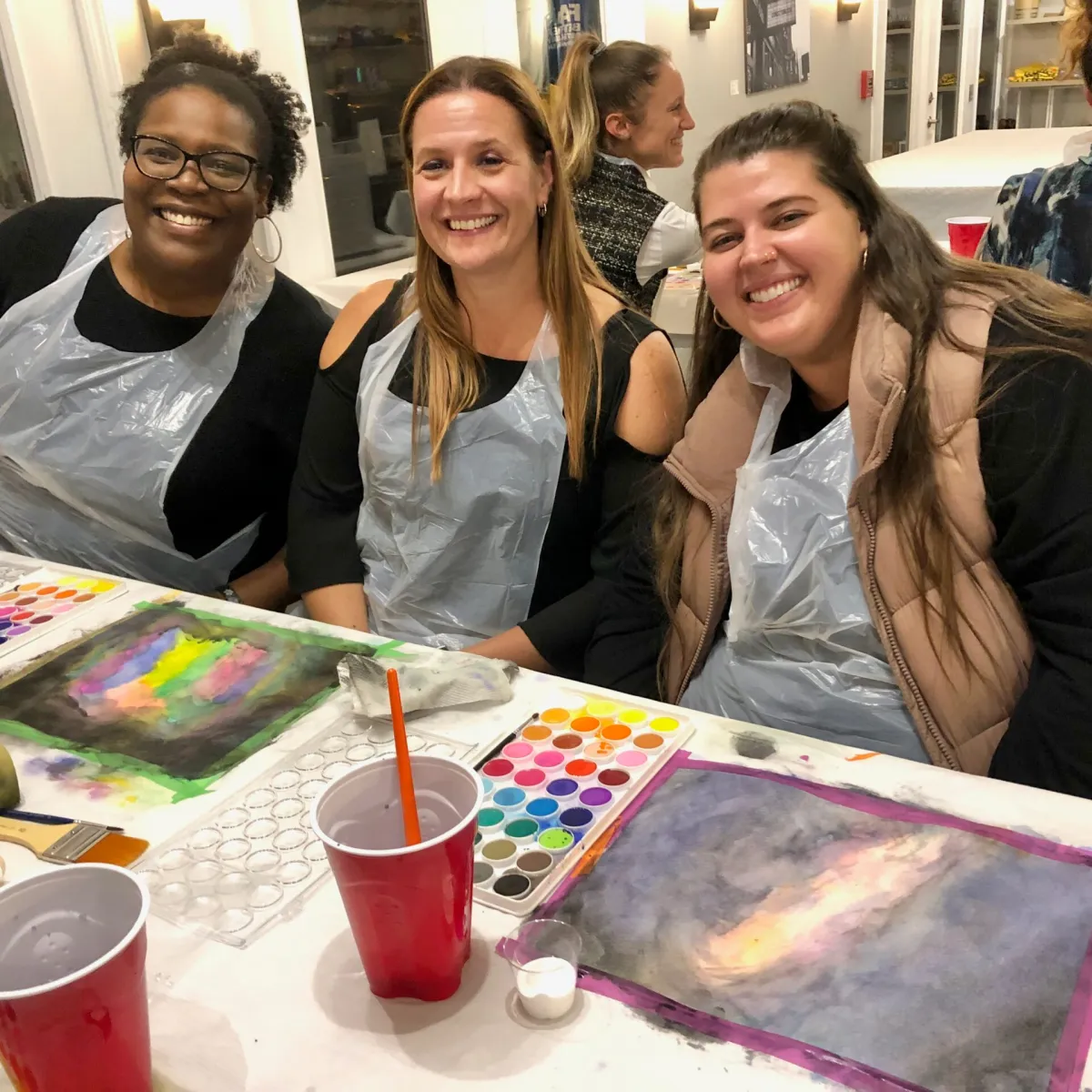 a group of people sitting at a table posing for the camera