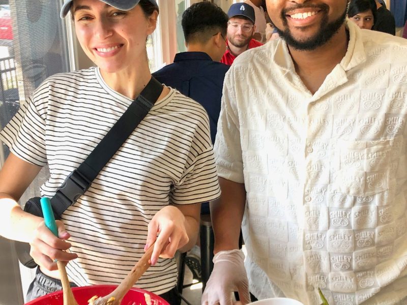 a man and a woman standing in front of a cake