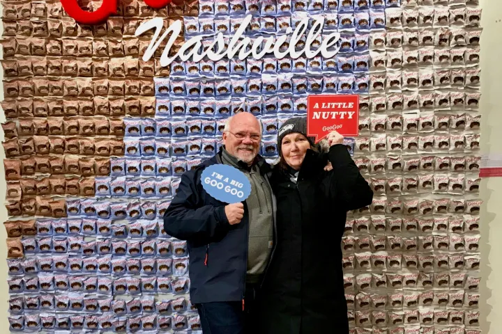two people in front of a sign