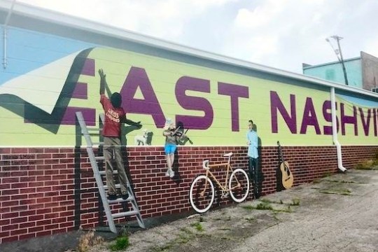 a sign in front of a brick building