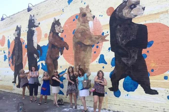 a group of people standing next to a dog