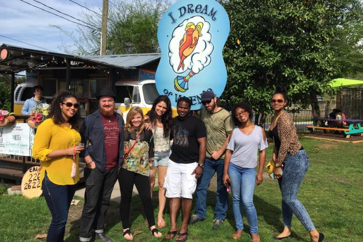 a group of people that are standing in the grass