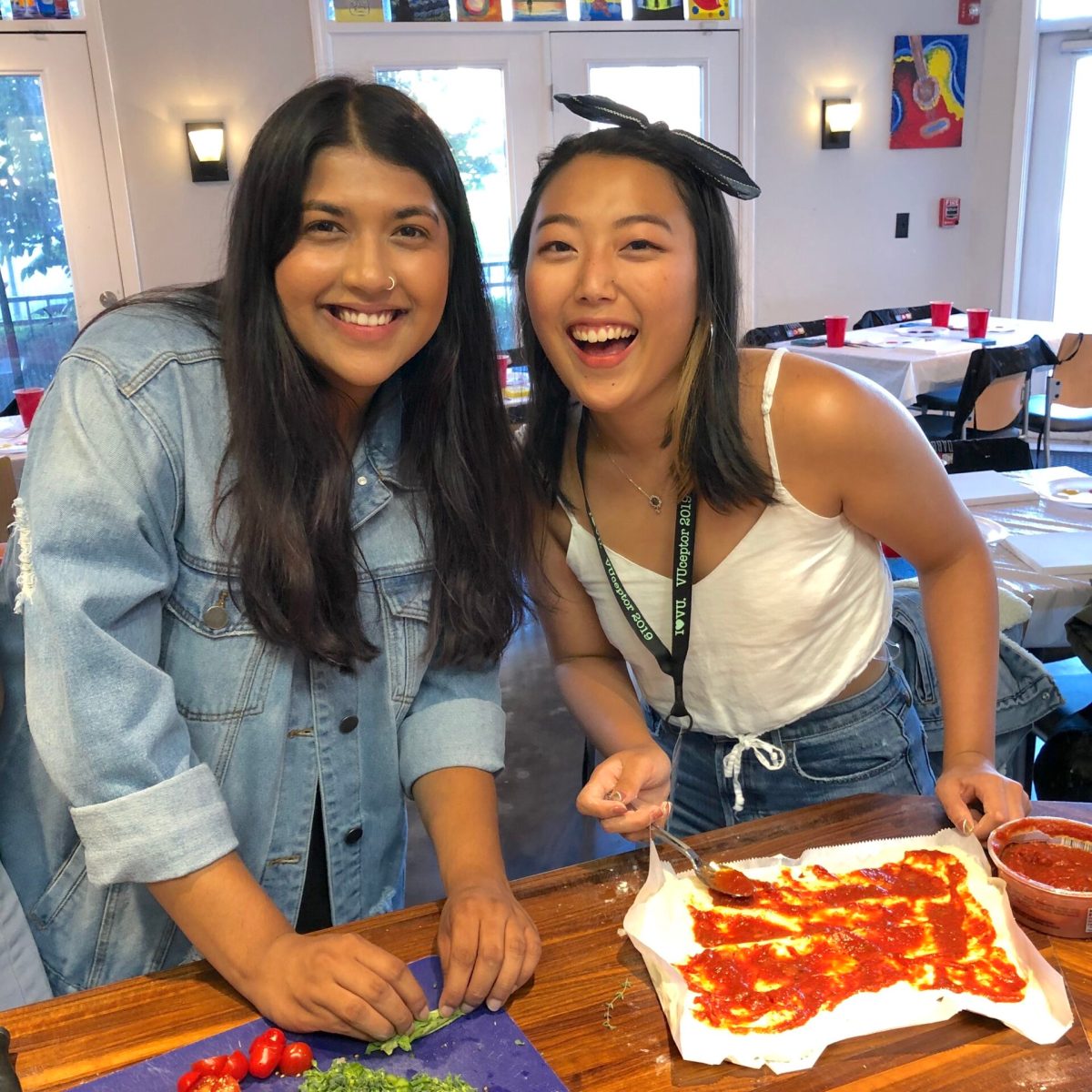 two women making pizza