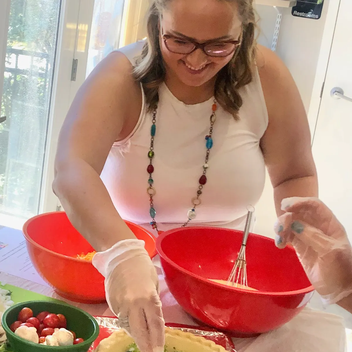 a woman sitting at a table with a bowl of food